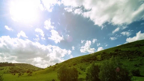 4K UHD mountain meadow timelapse at the summer. Clouds, trees, green grass and Video stock 129263910