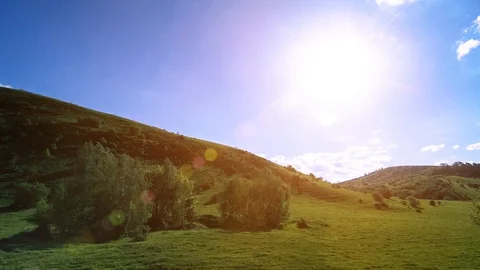 4K UHD mountain meadow timelapse at the summer. Clouds, trees, green grass and Stock Footage 129264540