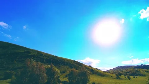 4K UHD mountain meadow timelapse at the summer. Clouds, trees, green grass and Stock Footage 152578385