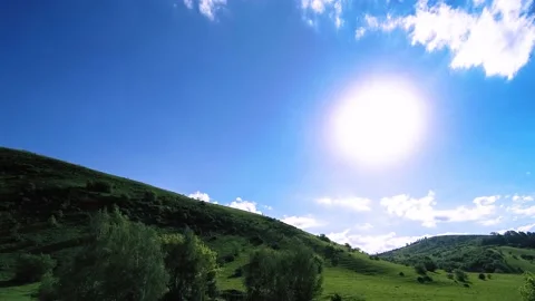 4K UHD mountain meadow timelapse at the summer. Clouds, trees, green grass and Stock Footage 152579678