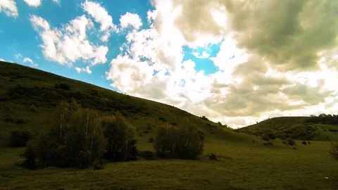 4K UHD mountain meadow timelapse at the summer. Clouds, trees, green grass and Stock Footage 152580218