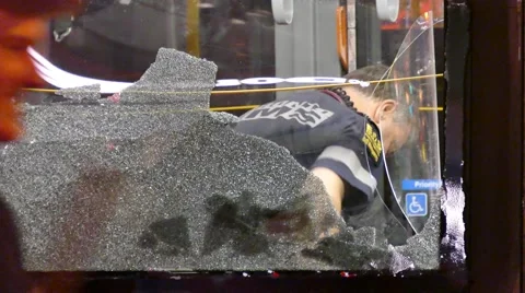 4K UHD - Paramedic viewed through shattered bus window 스톡 동영상 56441211