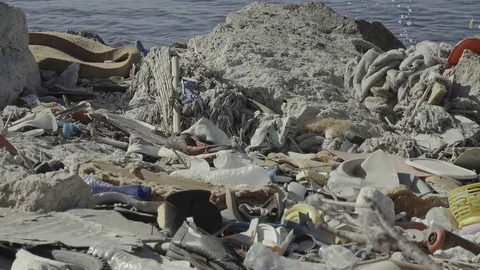 4K UHD Pile of plastic garbage on sea shore of industrial port Stock Footage 74072120