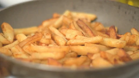 4K UHD Potatoes are fried on a frying pan Stock Footage 63174387