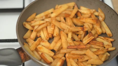 4K UHD Potatoes are fried on a frying pan Stock Footage 63174399