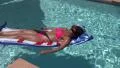 4K UHD swimming pool relax floating by pink bikini woman 4 4k or 4k+ Resolution