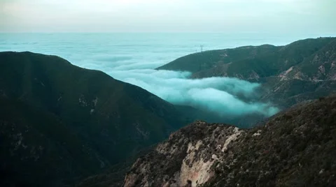 4K UHD Time lapse of clouds moving through a mountain side. Sea of clouds Stock Footage 65203676