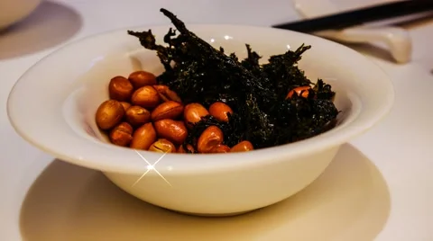 4k UHD time lapse video on eating a mixture of baked seaweed and roasted peanut Stock Footage 46981073