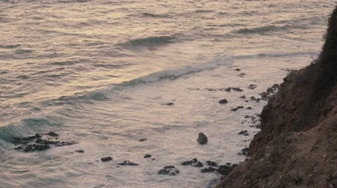 4K UHD Waves at sunset next to a canyon Stock Footage 62681379