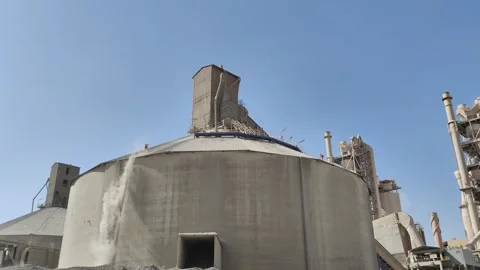 4K UHD Workers cleaning on top of a massive silo at a cement factory Stock Footage 339504037