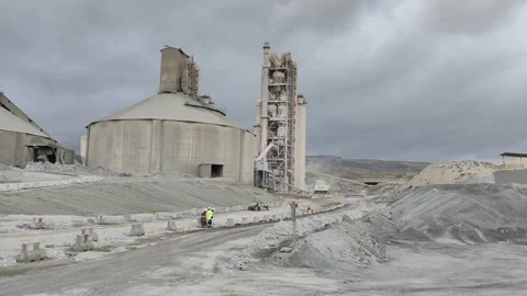 4K UHD: Workers in Safety Gear near Massive Cement Silos. Stock Footage 331861659
