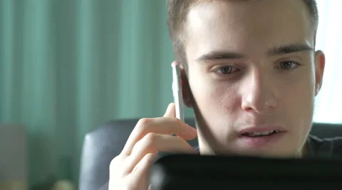 4k UHD - Young man browsing on a tablet pc and talking on the phone Stock Footage 46817868