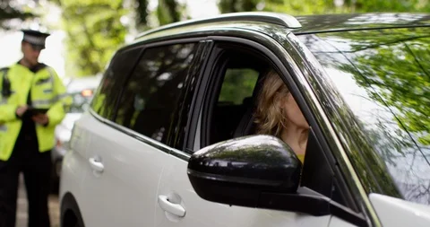 4K UK Traffic cop talking to female motorist after pulling her over  Stock Footage 113685854