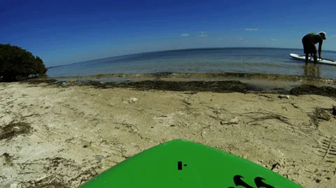 4K ULTRA HD Dropping a paddle board into the water-view from board Stock-Footage 35894357
