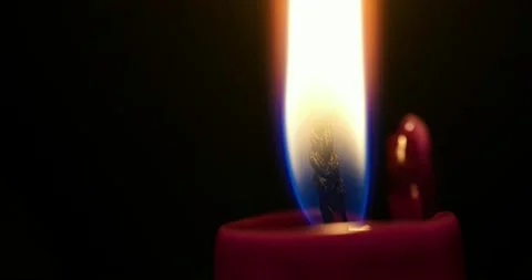 4k ultra macro time lapse of burning flame from red candle getting shorter Stock Footage 168745009