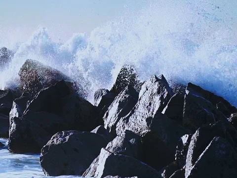  4K ultra The waves hit the rocks on the beach slow motion Stock Footage 84826278