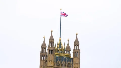 4k Union jack flag blows in the wind on top of British parliament Stock Footage 82552964