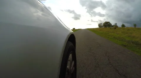 4K Unique angle showing a car speeding along a country lane Vidéo 68678671