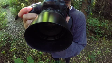 4K Unique perspective of photographer taking photos of nature in the woods Stock Footage 68678928