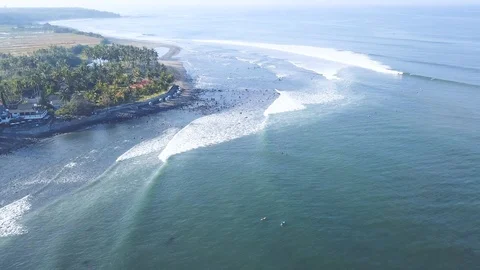 4K Unknown surfers riding waves on Medewi point break Stock Footage 115506660