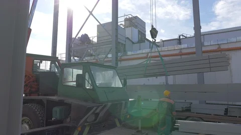 4K Unloading Оf Steel Beams On A Construction Site With Crane And Workers Video stock 127369987