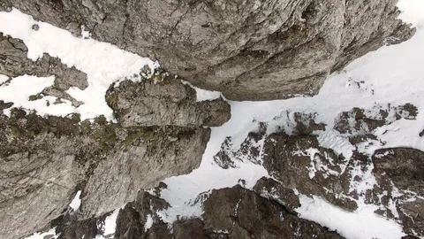 4K upward flight over rocky and snow alpine mountain summit Video stock 80435044