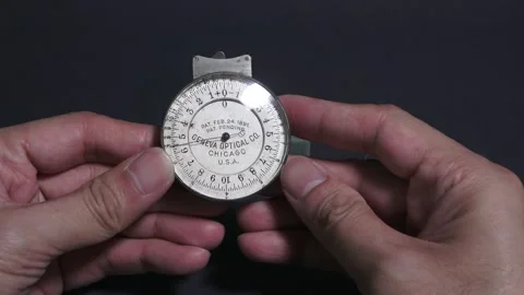 4K Using a 1891 Pre-Patent Geneva Lens Measure to Gauge a bi-concave lens Stock Footage 283423259