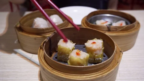 4K Using chopsticks eating Siu mai or Shao Mai (steam minced pork shrimp dimsum) Stock Footage 95964363