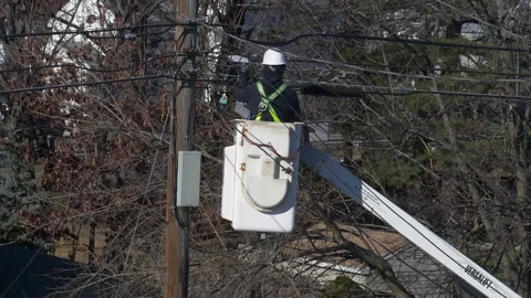 4K Utility Pole worker repairs cable wire line connections Video stock 233532639