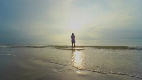 4K VDO backside solo asian woman relax and take photo by her phone on beach with Stock Footage 148282446
