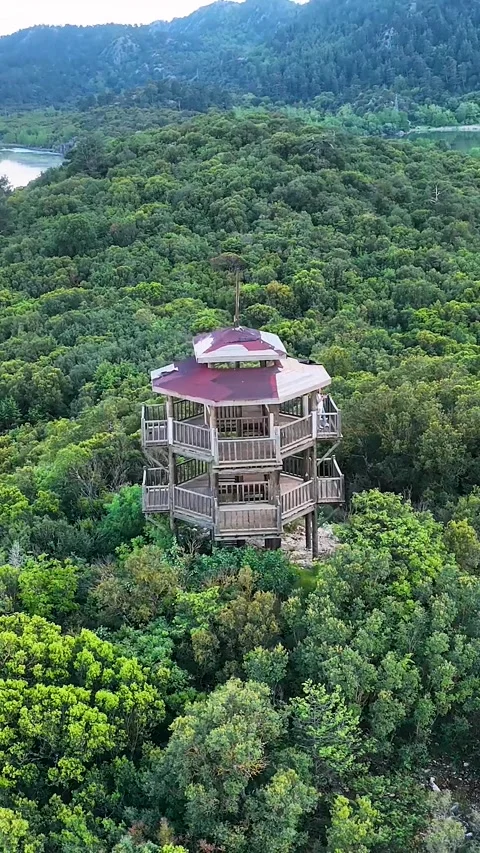 4K vertical aerial drone orbit of observation tower at Kovada Lake and forest Stock Footage 336449858