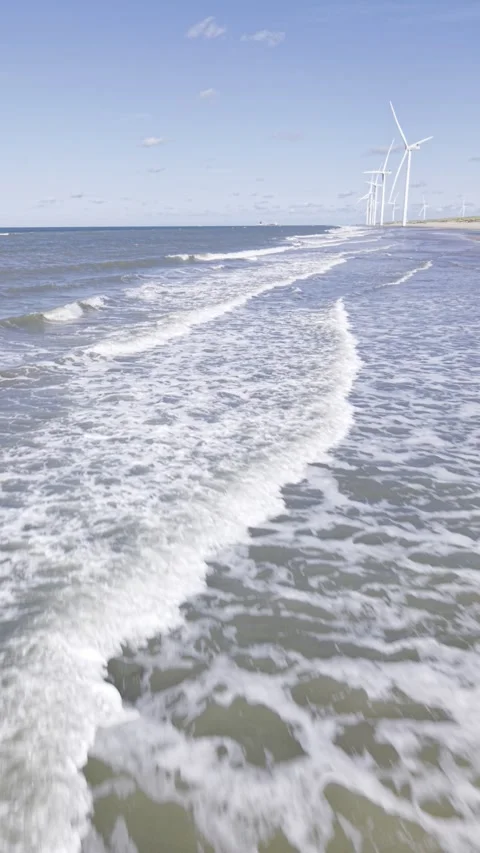 4K Vertical Aerial View of Waves Crashing on Rotterdam North Sea Beach Stock Footage 344741685