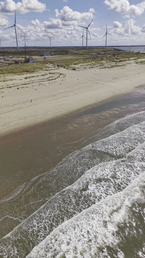 4K Vertical Aerial View of Waves Crashing on Rotterdam North Sea Beach Stock Footage 344742216