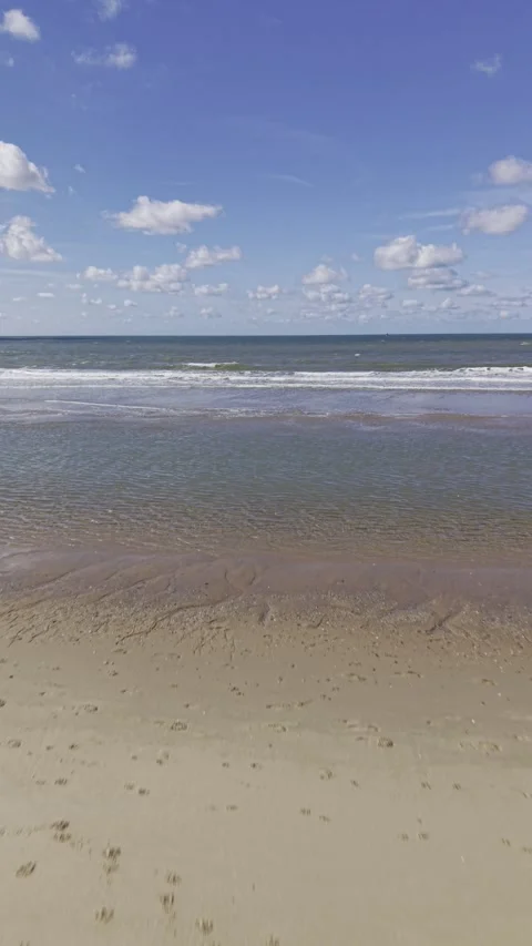 4K Vertical Aerial View of Waves Crashing on Rotterdam North Sea Beach Stock Footage 344743147