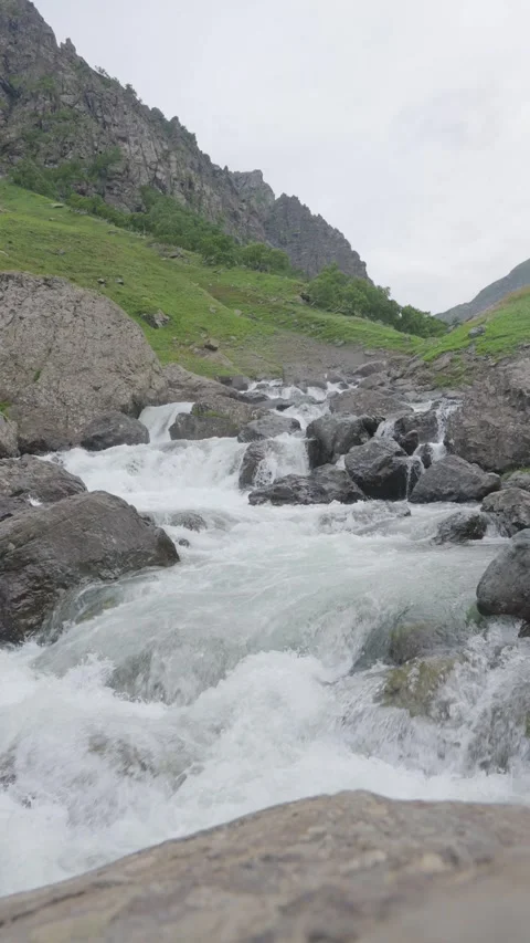 4k vertical clip of mountain stream cascading in valley Stock Footage 341516235