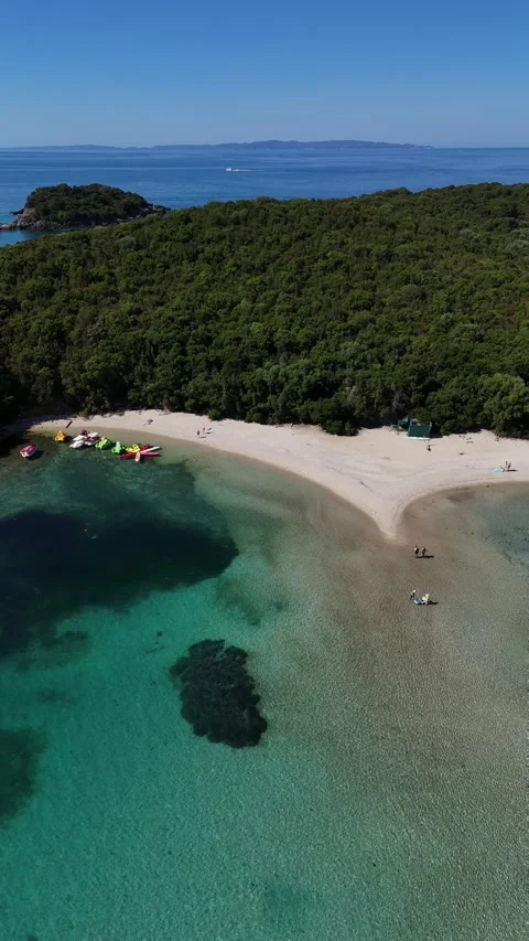 4K vertical drone footage of secluded turquoise sea cove and sandy beach in Sivo Stock Footage 340560599