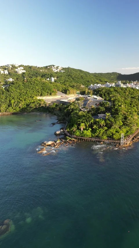 4K Vertical Drone Orbit of Coastal Rocks in Bright Sunlight Stock Footage 311553231
