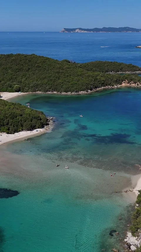 4K vertical drone shot of Bella Vraka sandbar beach and shallow turquoise lagoon Stock Footage 340566744