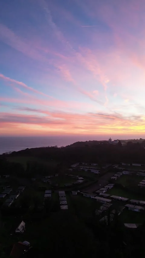 4K Vertical Drone Shot of Cromer Lighthouse Over the Ocean at Sunrise Video stock 296225102