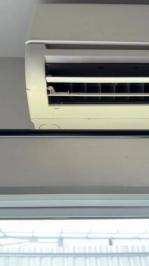 4K vertical frontal view of water dripping steadily from an air conditioner unit Stock Footage 342777246