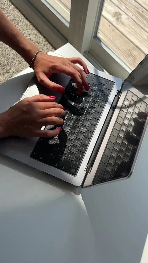 4K vertical overhead video of female typing on a laptop keyboard Stock Footage 342062944
