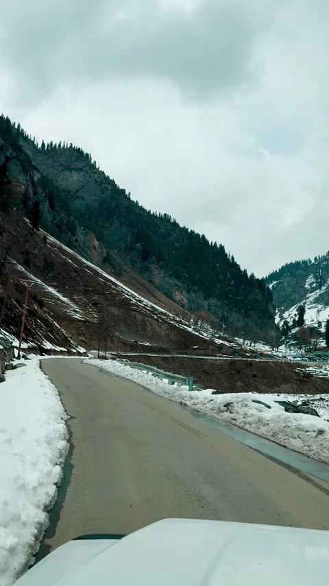 4K vertical POV shot of driving on the snowy road in winter season at Kashmir, I Stock Footage 340574228