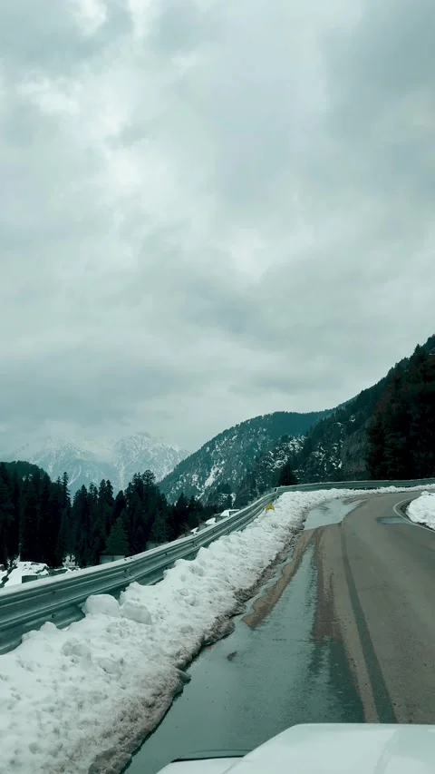 4K vertical POV video of car driving on empty road through winter landscape in P Stock Footage 340574237