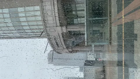 4K Vertical Rain Running down on a Big Window Glass at Sapporo City Stock Footage 157850448