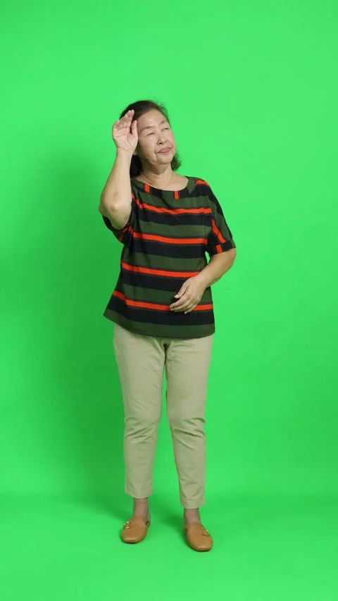 4K vertical shot of an elderly Asian woman wiping sweat from her forehead and ch Stock Footage 342777530