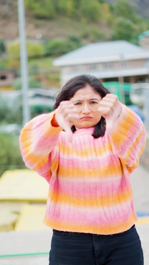4K vertical shot of Young Indian woman showing thumbs-down gesture.  Stressed la Stock Footage 306920121