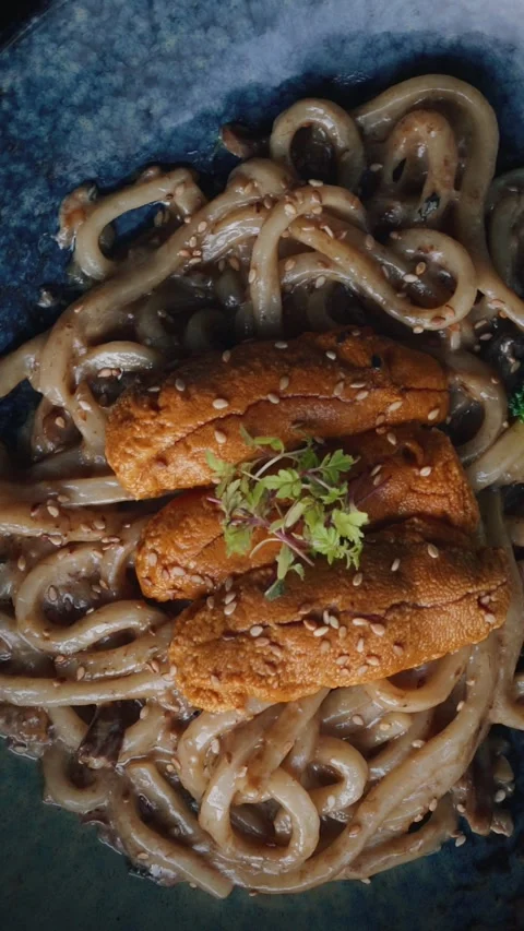 4K vertical spinning overhead udon noodles with sea urchin Stock Footage 315395573