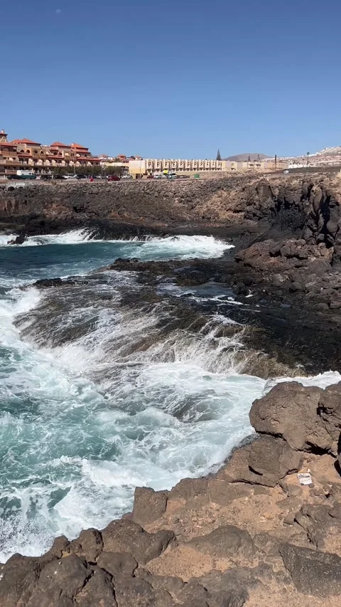 4K vertical static shot of Atlantic Ocean waves crashing against volcanic rocks Видео 339621227
