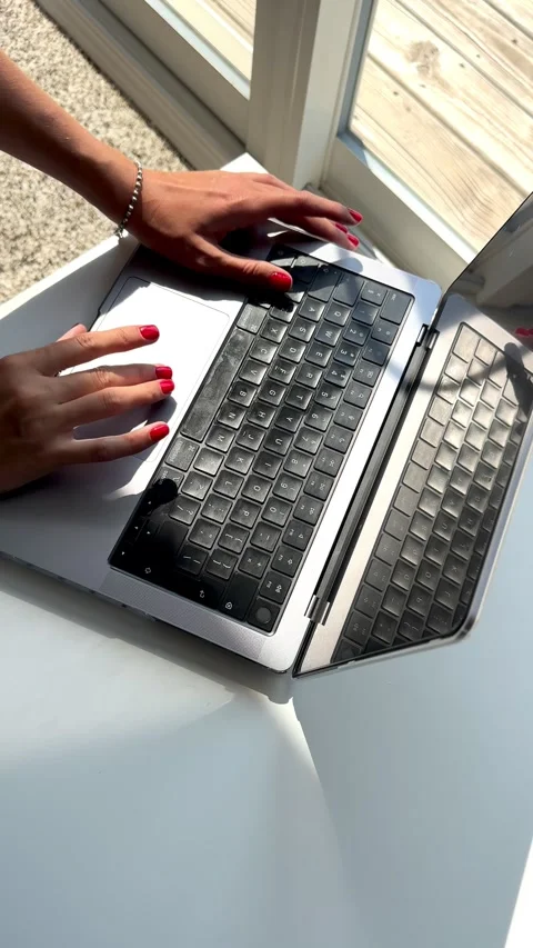 4K vertical top-down video of a woman's hands typing on a laptop keyboard Stock Footage 342062940