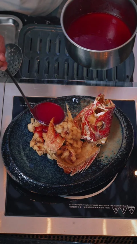 4K vertical video chef plating deep fried snapper with balsamic raspberry sauce Stock Footage 315395482